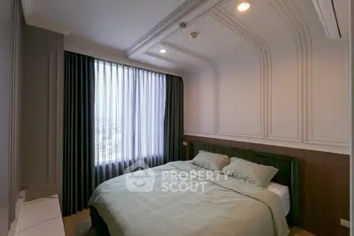 Elegant bedroom with stylish paneling and large window offering natural light