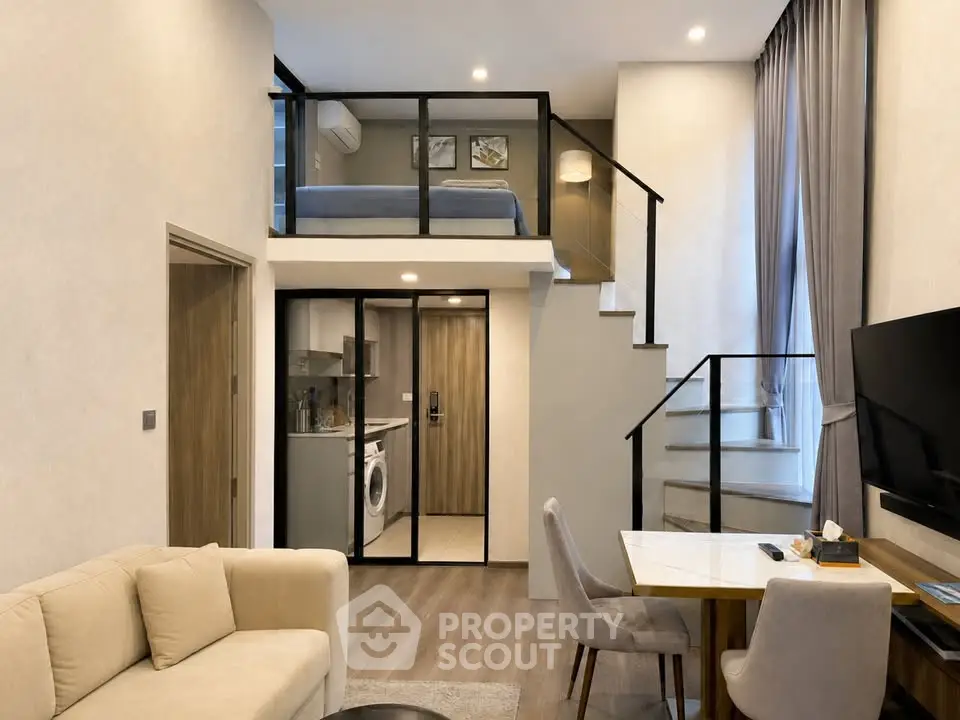 Modern loft apartment with mezzanine bedroom and stylish open-plan living area, featuring a cozy sofa and dining space.