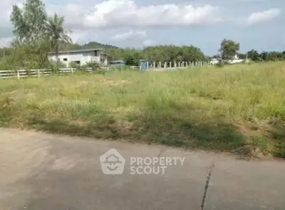 Expansive plot of land with lush greenery and clear skies, ideal for development opportunities.