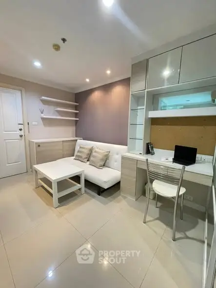 Modern living room with sleek furniture and built-in study area