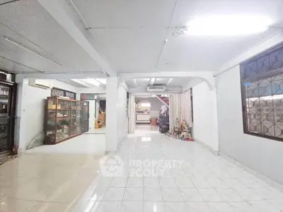 Spacious open-plan living area with tiled flooring and ample natural light, perfect for customization.