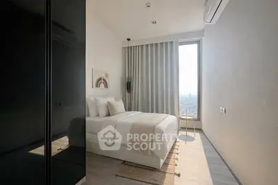 Modern minimalist bedroom with large window and city view, featuring neutral tones and stylish decor.
