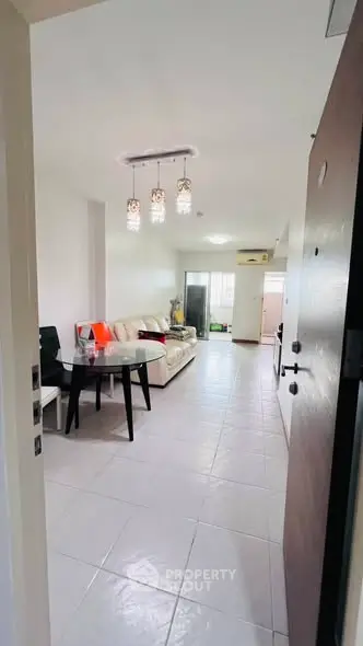 Spacious living room with modern decor and elegant lighting in a cozy apartment.