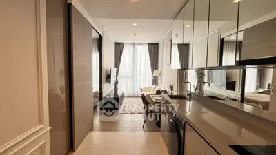 Modern open-plan kitchen and living area with sleek design and natural light