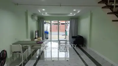 Spacious living room with modern decor and large windows for natural light.