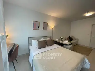 Modern studio apartment with cozy bedroom and stylish living area, perfect for urban living.