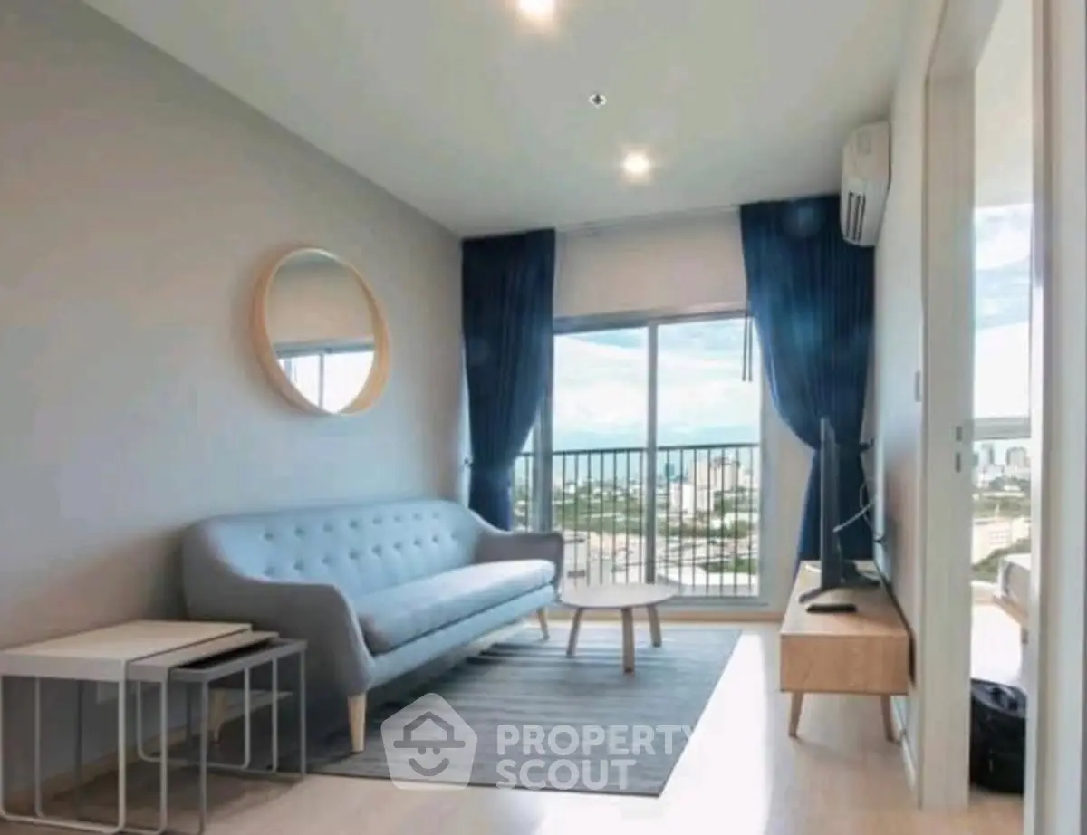 Modern living room with city view, stylish furniture, and natural light.
