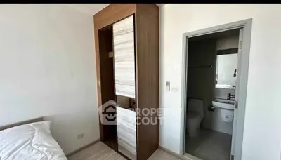 Modern bedroom with ensuite bathroom and sleek wardrobe design
