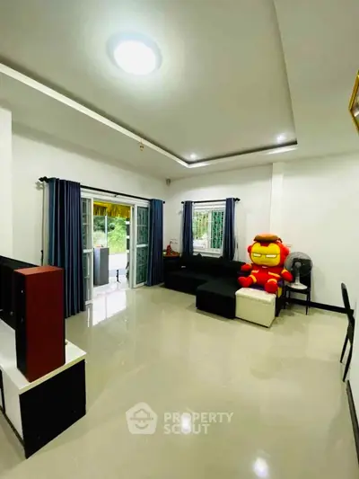 Spacious living room with modern decor and large windows for natural light.