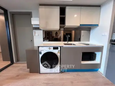 Modern kitchen with integrated washing machine and sleek cabinetry