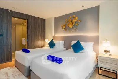 Luxurious twin bedroom with modern decor and ensuite bathroom
