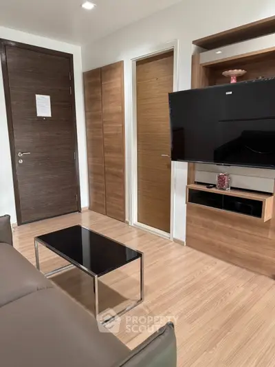 Modern living room with sleek wooden furniture and wall-mounted TV
