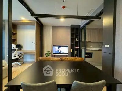 Modern open-plan living room with stylish furniture and integrated kitchen area.