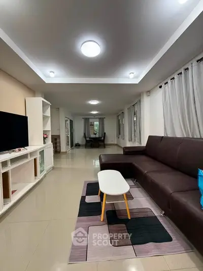 Spacious modern living room with sleek furniture and ample natural light