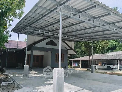 Spacious residential property with large covered carport and modern exterior design.