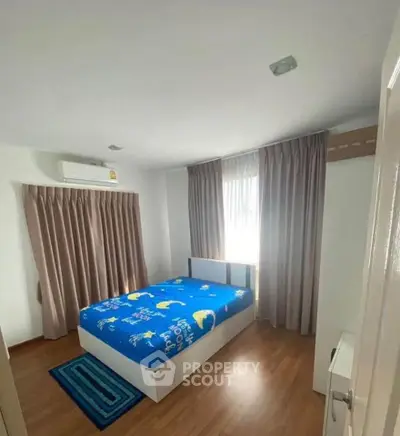 Cozy bedroom with wooden flooring and modern decor