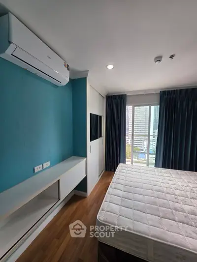 Modern bedroom with air conditioning and city view from window