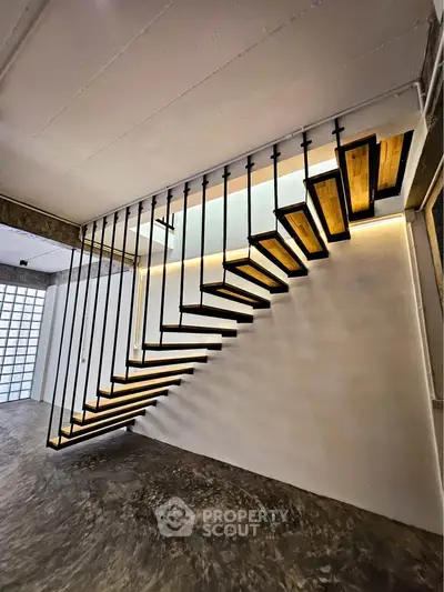 Modern industrial staircase with sleek design and ambient lighting