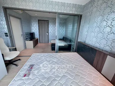 Modern bedroom with elegant wallpaper and sliding glass doors