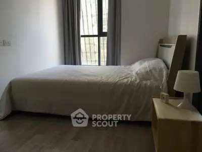 Cozy minimalist bedroom with large window and modern decor