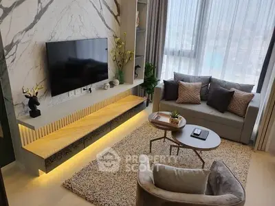 Stylish modern living room with elegant decor and large window view.