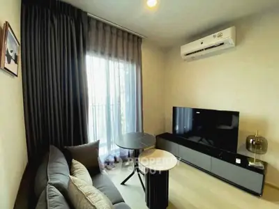 Modern living room with sleek furniture and large TV, featuring elegant curtains and air conditioning.