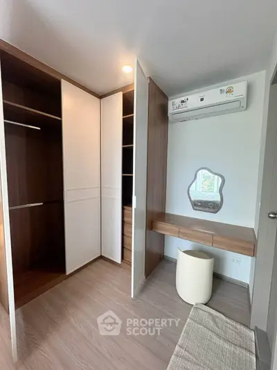 Modern bedroom with built-in wardrobe and stylish vanity area