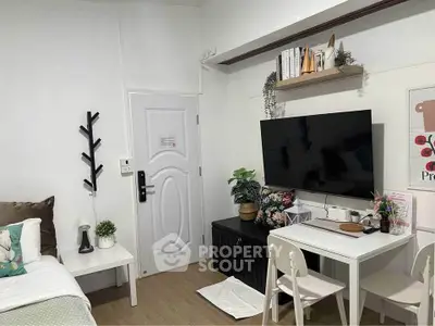 Cozy studio apartment with modern decor and smart TV setup.