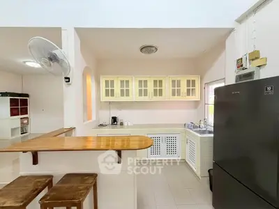 Charming kitchen with open layout and modern appliances, featuring a breakfast bar and ample storage space.