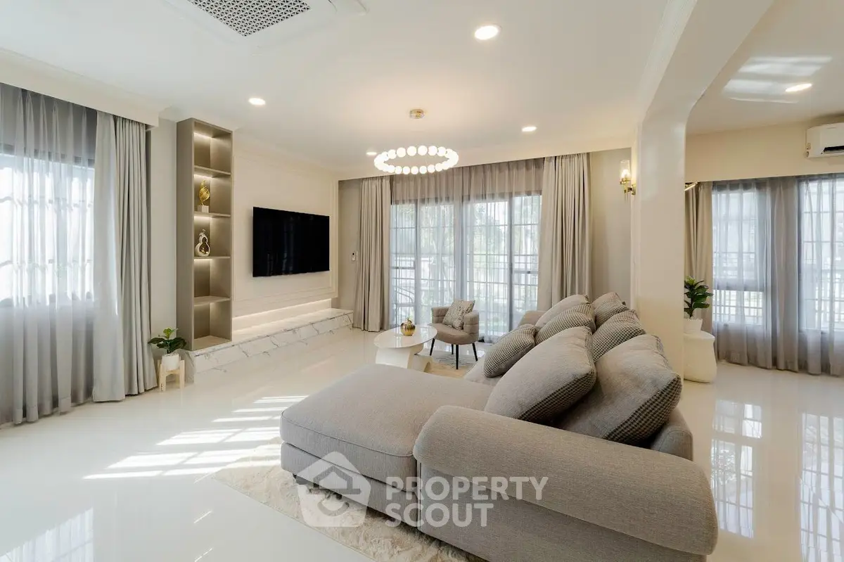 Spacious modern living room with elegant decor and large windows for natural light.