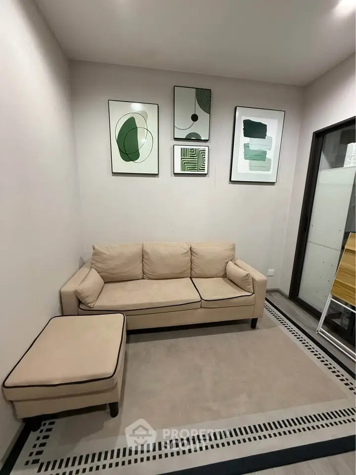Cozy living room with modern art and beige sofa, perfect for relaxation.