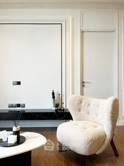 Elegant modern living room with plush armchair and stylish decor