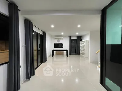 Spacious modern living room with sleek design and large windows