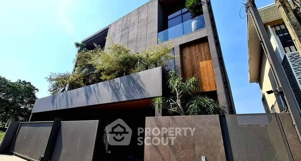 Modern architectural masterpiece with sleek design and lush greenery in urban setting.