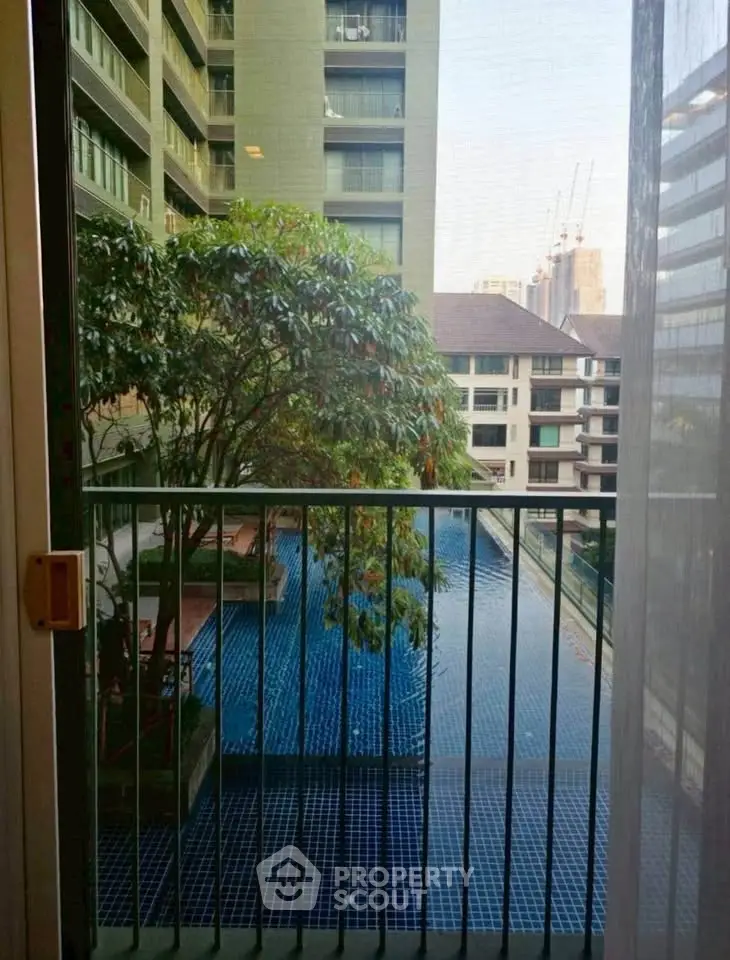 Stunning pool view from a high-rise apartment balcony, perfect for urban living.