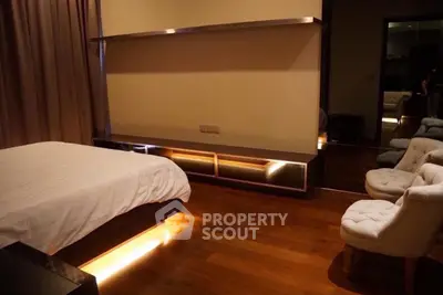 Luxurious bedroom with modern lighting and elegant wooden flooring