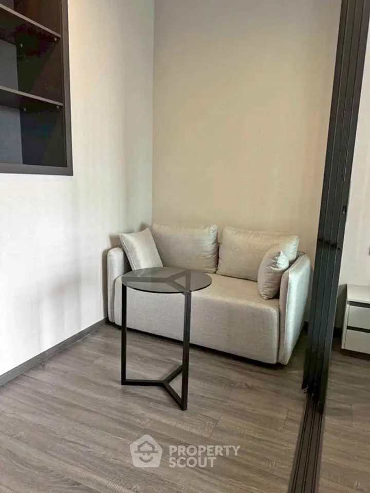 Cozy modern living room with stylish sofa and sleek side table, perfect for relaxation.