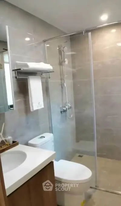 Modern bathroom with glass shower and sleek fixtures