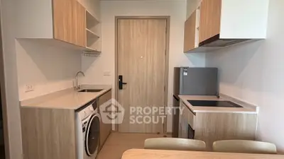 Modern compact kitchen with integrated appliances and wooden cabinetry