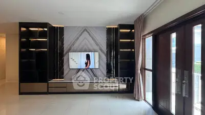 Luxurious living room with modern TV setup and elegant decor