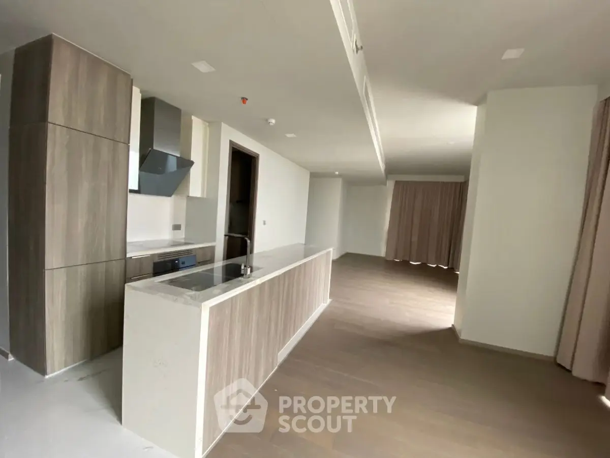 Spacious modern kitchen with sleek cabinetry and open layout in a contemporary apartment.