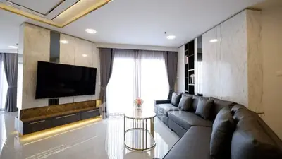 Luxurious modern living room with sleek design and large sectional sofa.