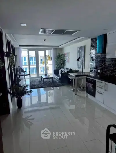 Modern open-plan living room with sleek kitchen and stylish decor