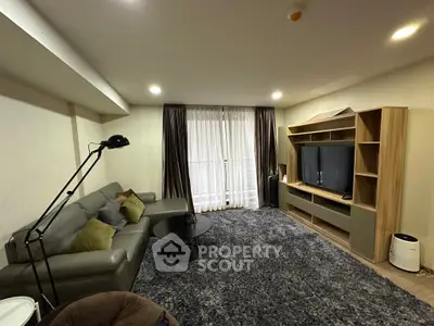 Spacious living room with modern furniture and entertainment center, perfect for relaxation and entertainment.