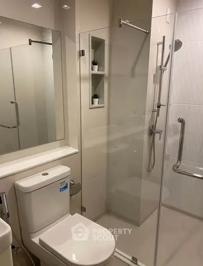 Modern bathroom with glass shower enclosure and sleek fixtures