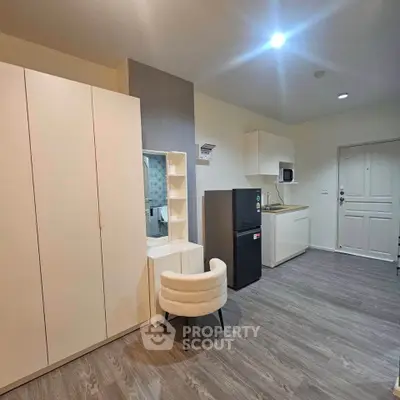 Modern studio apartment with sleek kitchen and stylish furniture