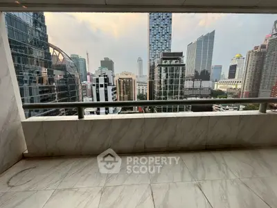 Stunning cityscape view from a spacious balcony in a high-rise building.