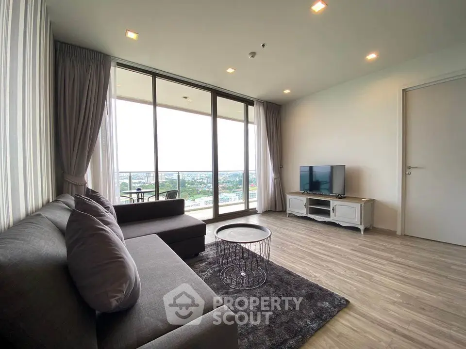 Spacious modern living room with large windows and stunning city view
