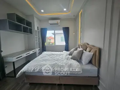 Luxurious bedroom with modern design, featuring a plush bed, built-in shelves, and large window with scenic view.