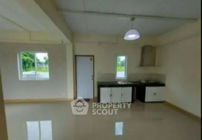 Spacious open-plan kitchen with modern cabinetry and ample natural light.